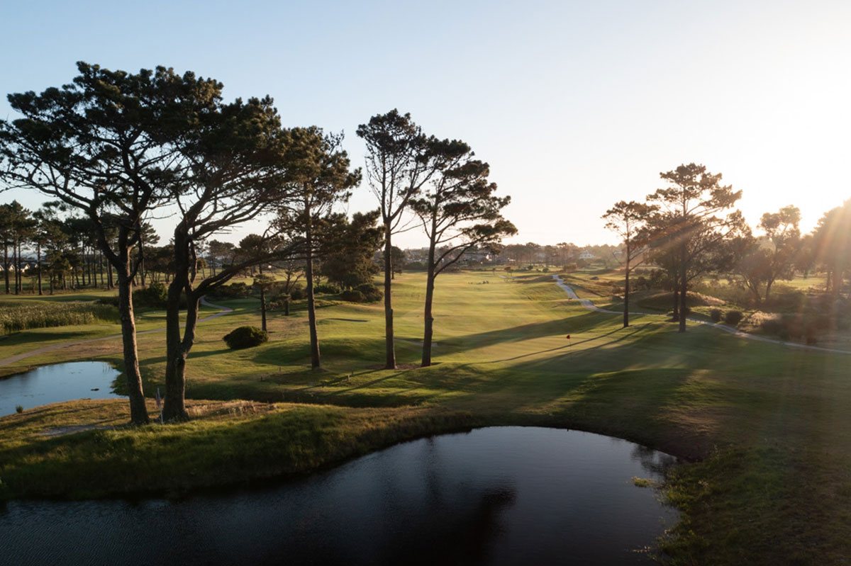 Golden light settles across the fairway at the end of a day’s golf